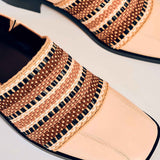 Detail shot of the woven detailing and stitching on the shoe.