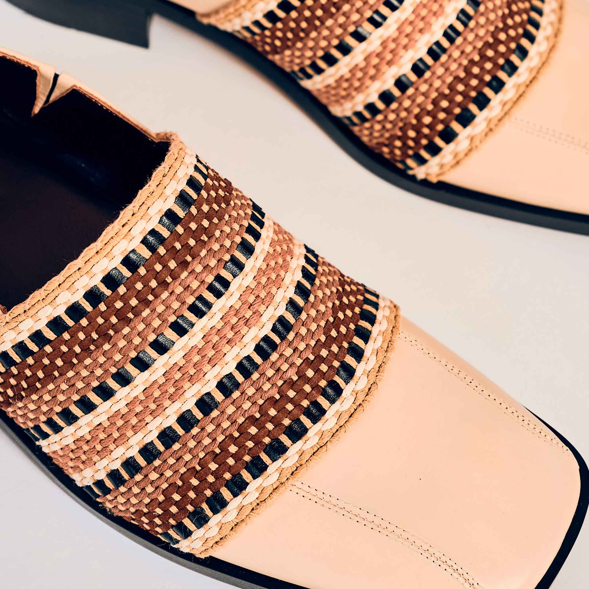 Detail shot of the woven detailing and stitching on the shoe.
