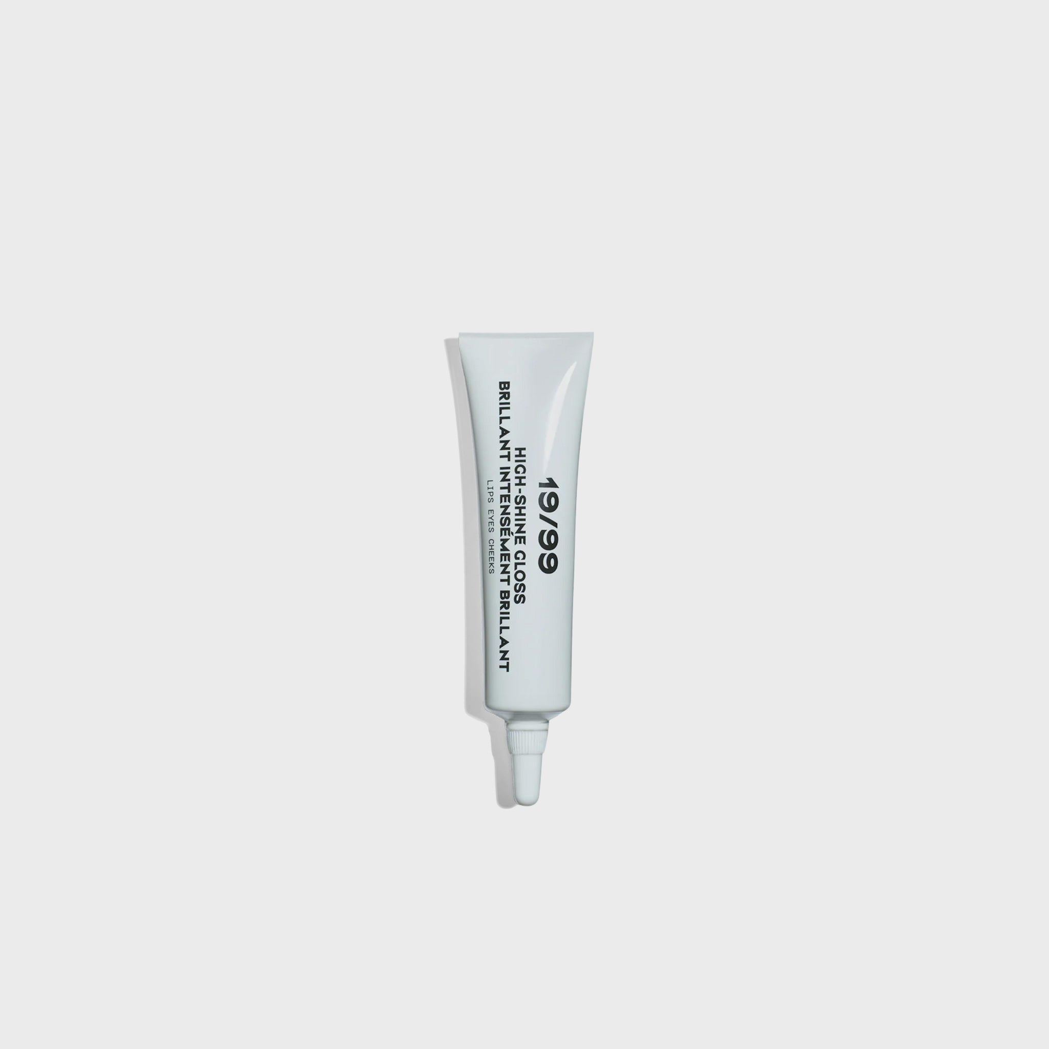 A small white tube with bold black 19/99 logo containing the brands signature high shine gloss.