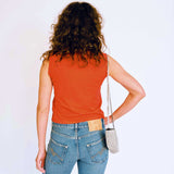 A model wears the red J'Adoro Aries sleeveless tee - back view.