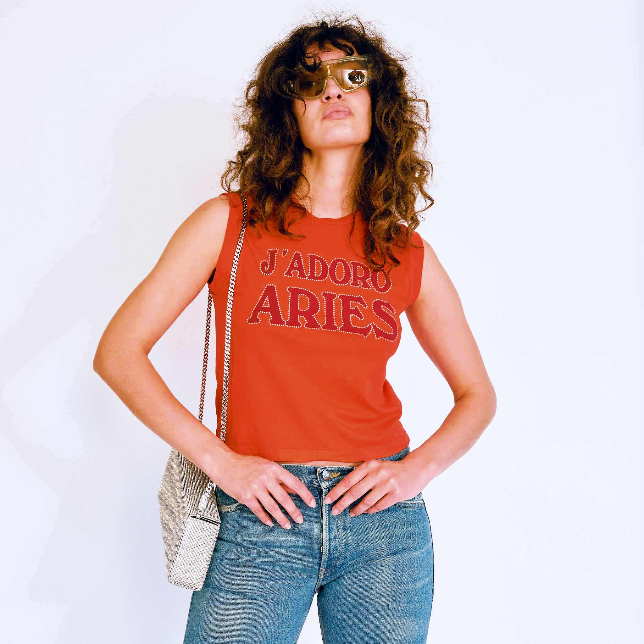 A model wears the red J'Adoro Aries sleeveless tee - front view.