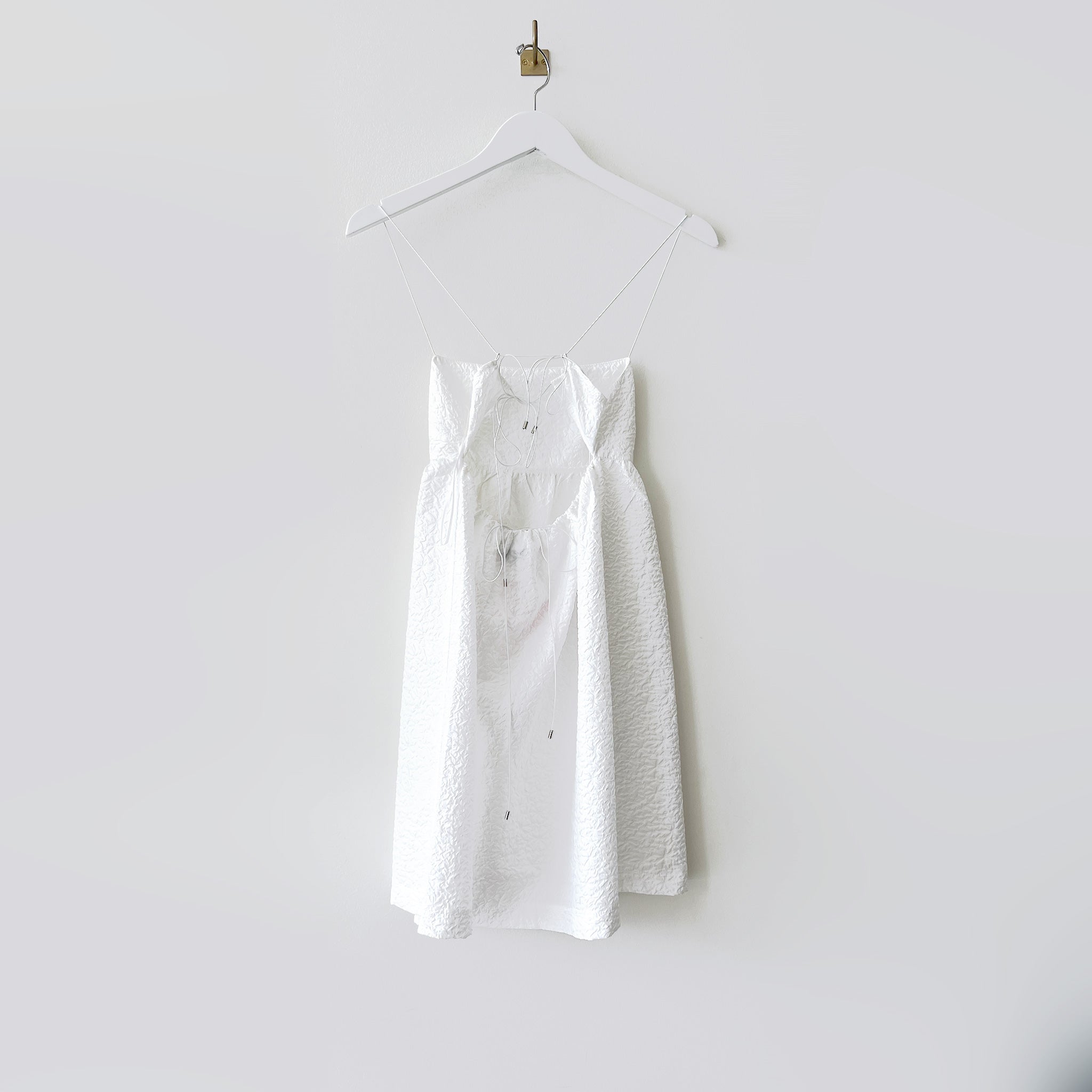 Back hanging photo of the Lace-Back Jacquard Mini Dress - White.