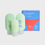 3 translucent mini bottles of DUNE's sun care hero products, stacked against their blue packaging box.