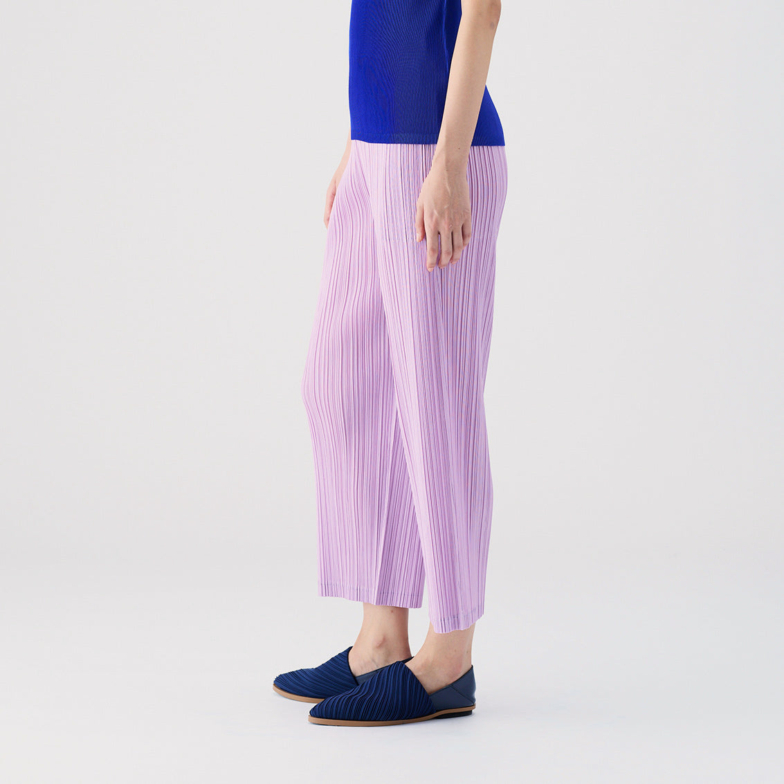 Side half body photo of model wearing the Thicker Bottoms Pants - Pink Purple.