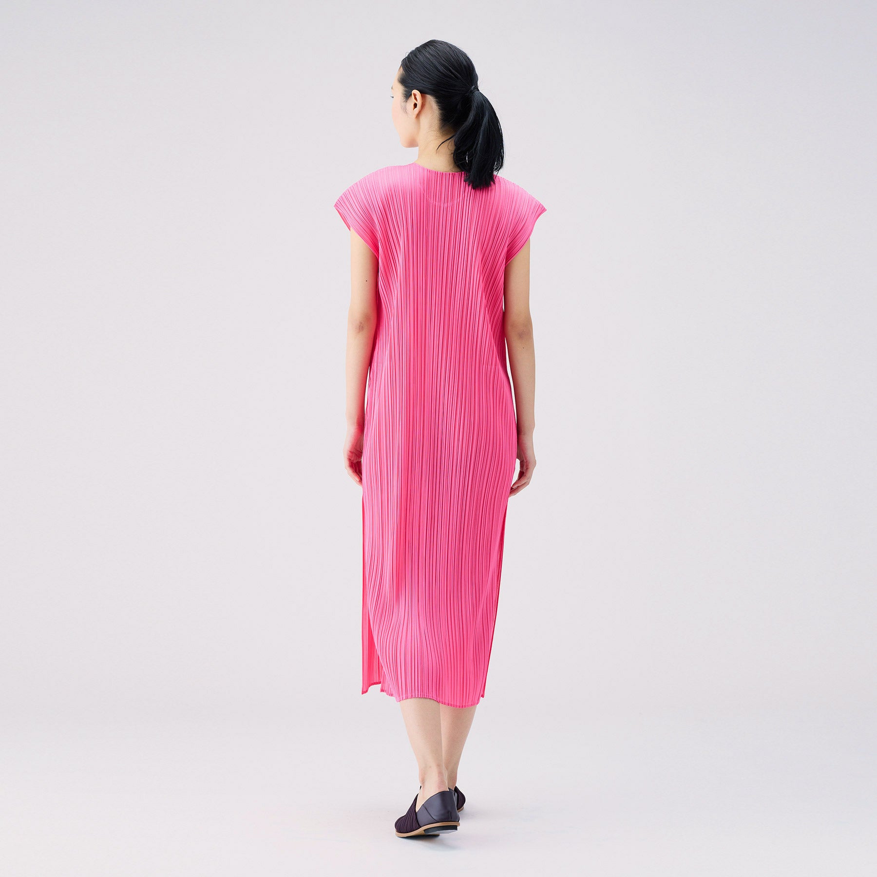 Back full body photo of model wearing the Monthly Colors July S/S Dress - Bright Pink.