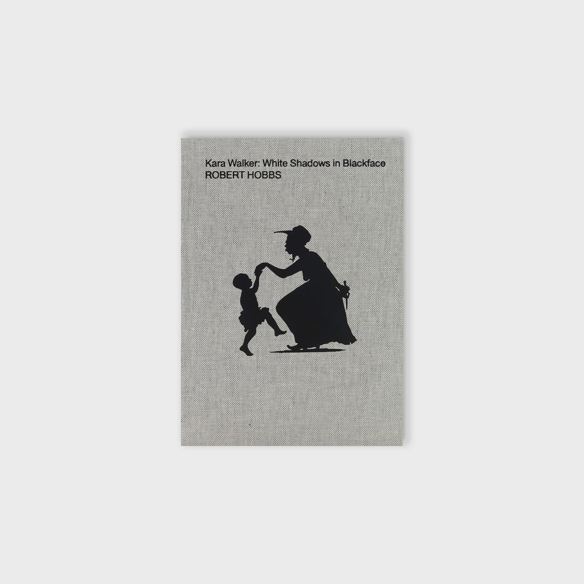 Fabric textured cover of Kara Walker's White Shadows in Blackface featuring a black silhouette of figures dancing.