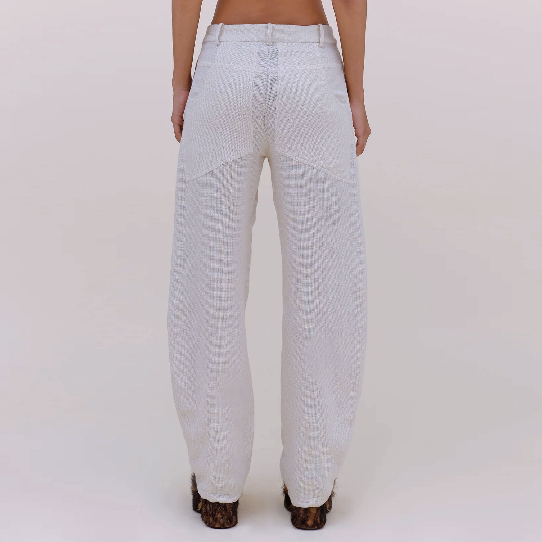 Back half body photo of model wearing the Linen Pant - Natural.