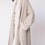 Detailed view of the Long Shawl Cardigan's front pockets.