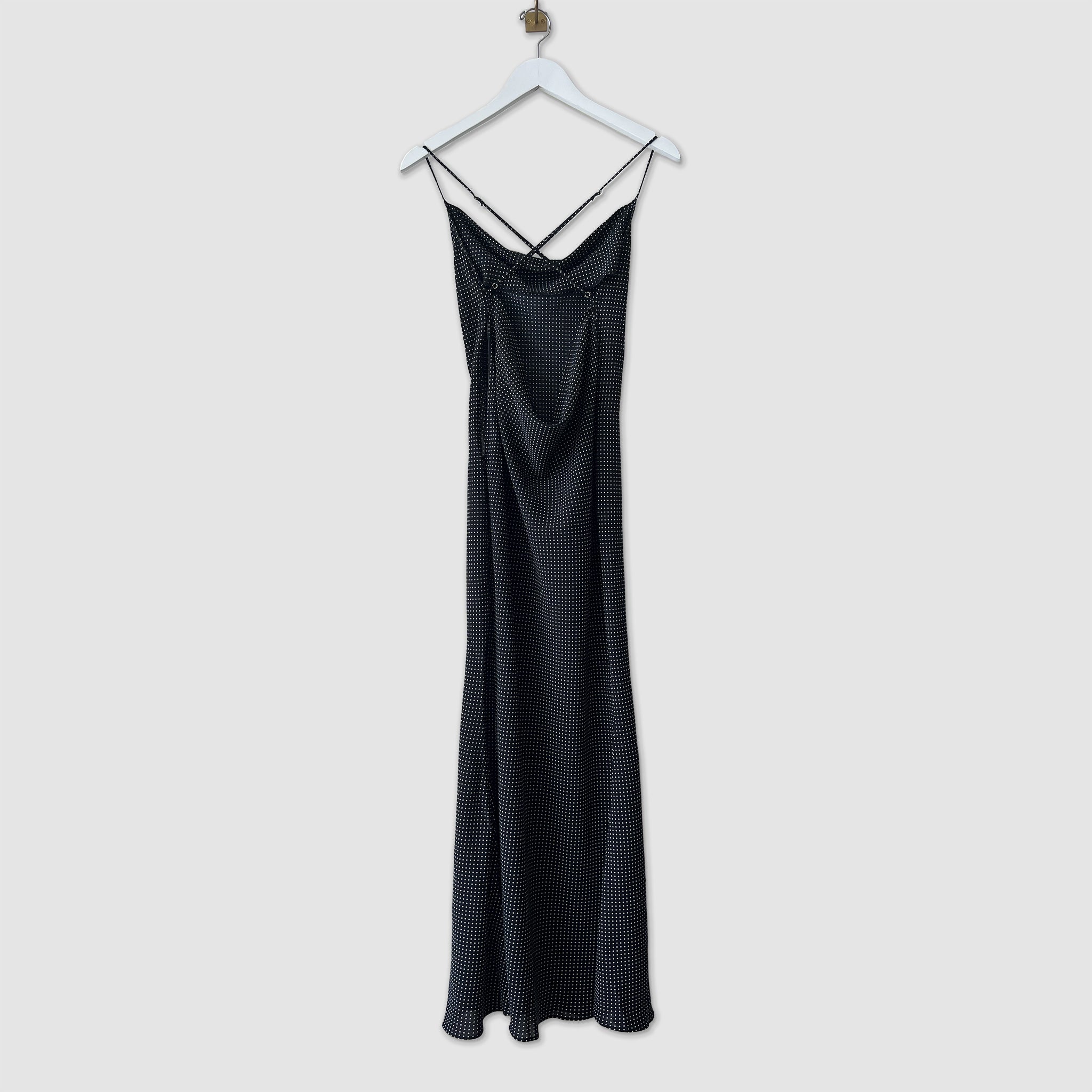 Cowl neck slip dress in black with tiny white dots, back view.
