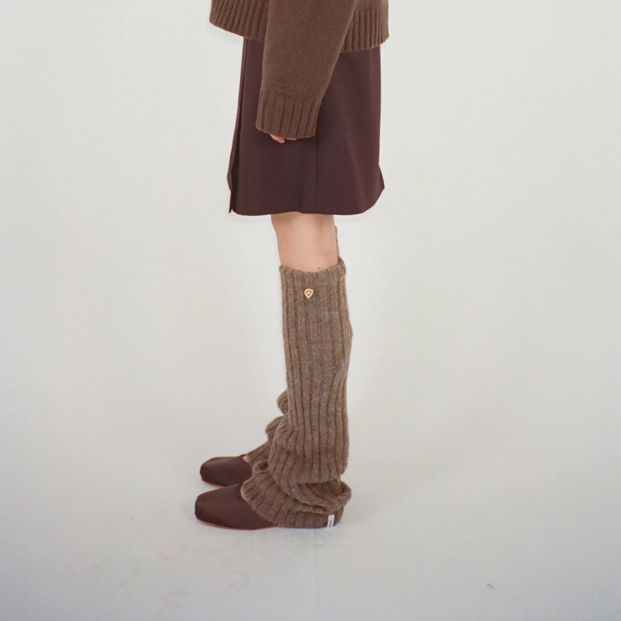 Side photo of model wearing the Luxy Leg Warmer - Brown.