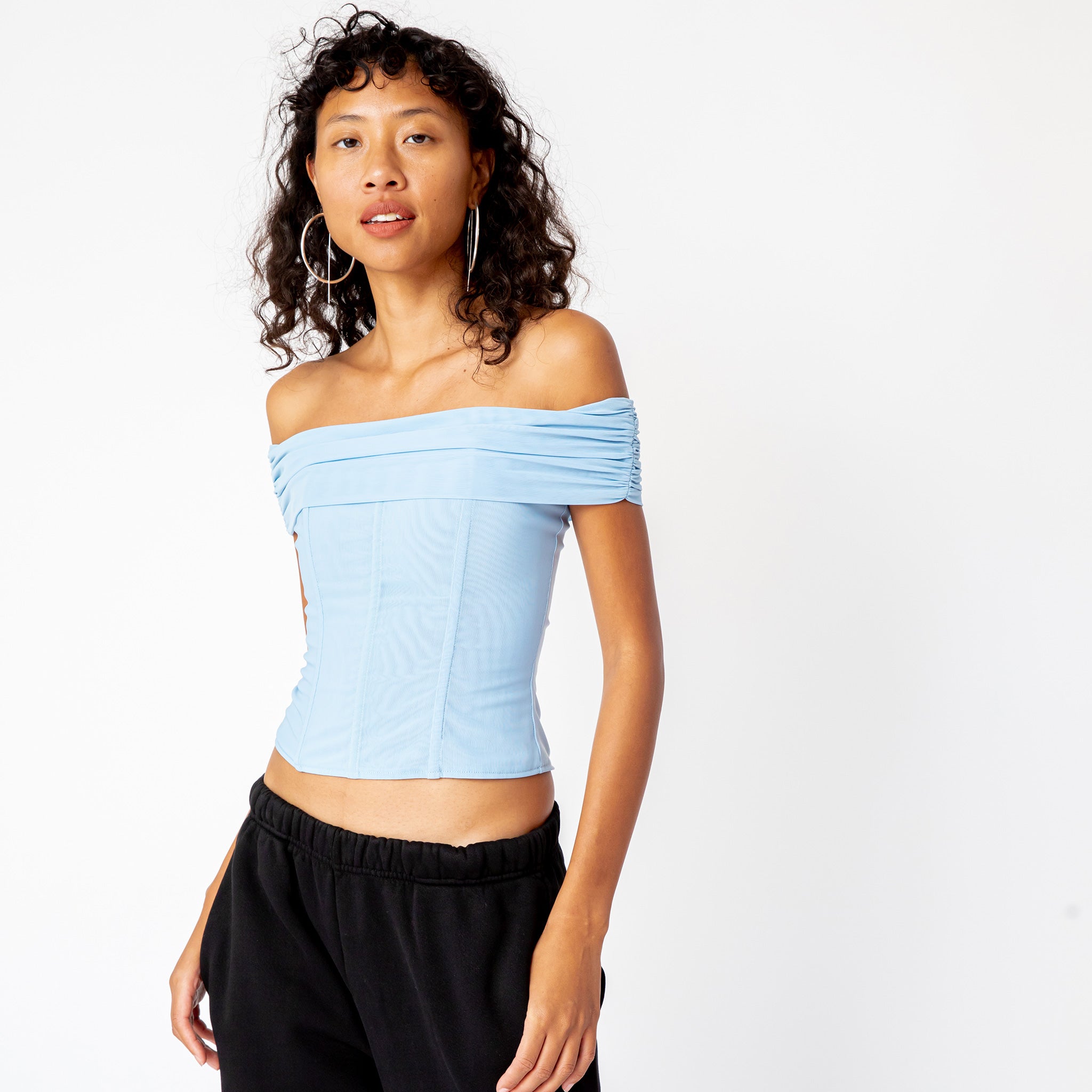 A model wears the light blue, off-shoulder Magda Corset from Miaou in a form-fitting mesh fabric - front view.