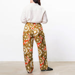 Back half body photo of model wearing the Marella Pants - Olea.