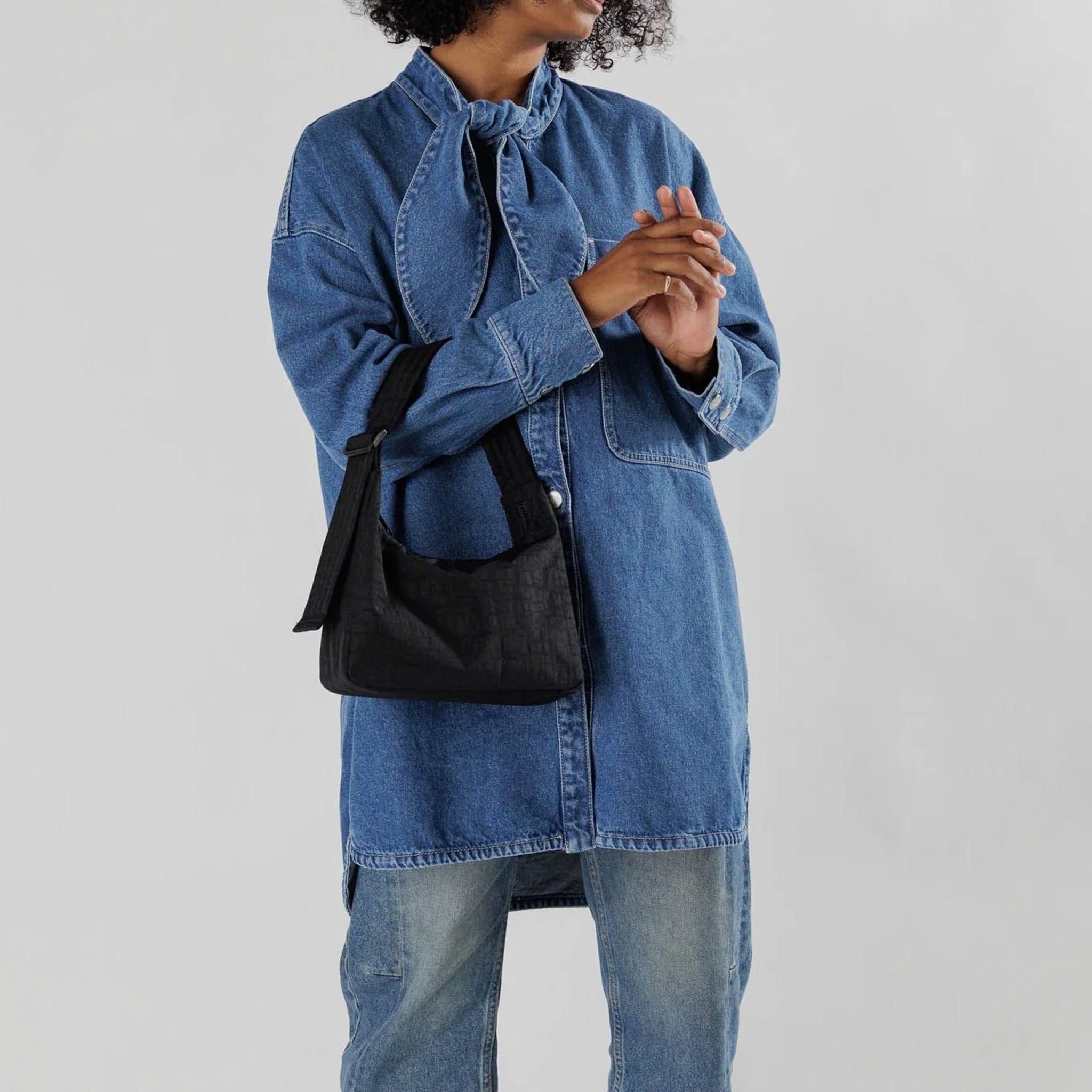 Close half body photo of model wearing the Mini Nylon Shoulder Bag - Black.