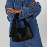 Close half body photo of model wearing the Mini Nylon Shoulder Bag - Black.