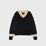 Flat photo of  a oversized black v neck sweater with a white and yellow line around the neck and wrists.