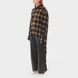 Front full body photo of model wearing a longlsleeve plaid flannel with a high low detail. Mullet Button Down - Check