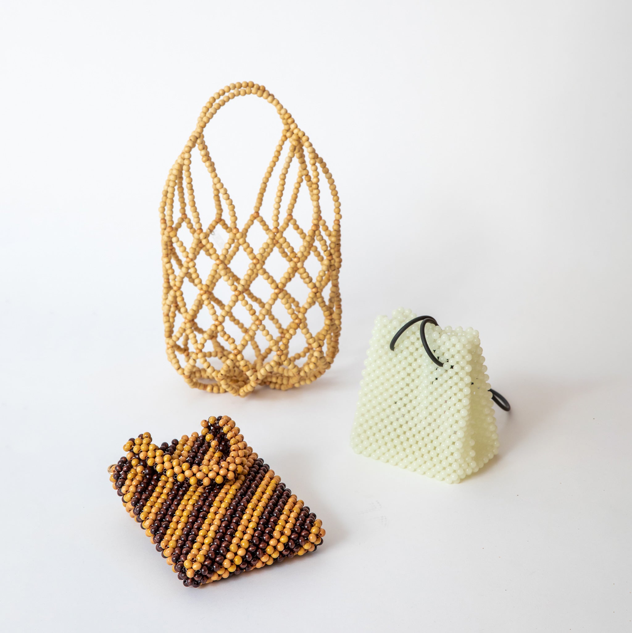 3 different Not Impressed beaded bags displayed against a white background.