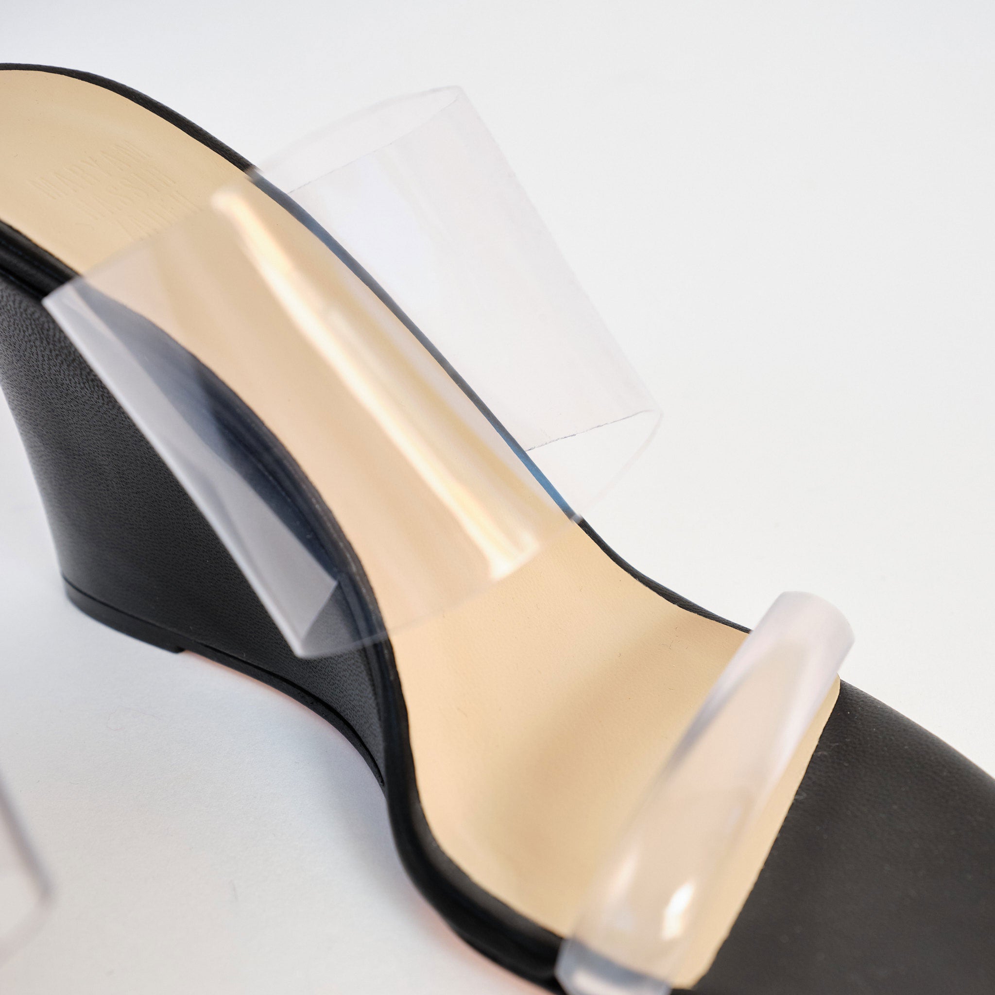 The iconic Olympia Wedge from Maryam Nassir Zadeh in black leather and clear perspex toe strap and vamp - detailed view.