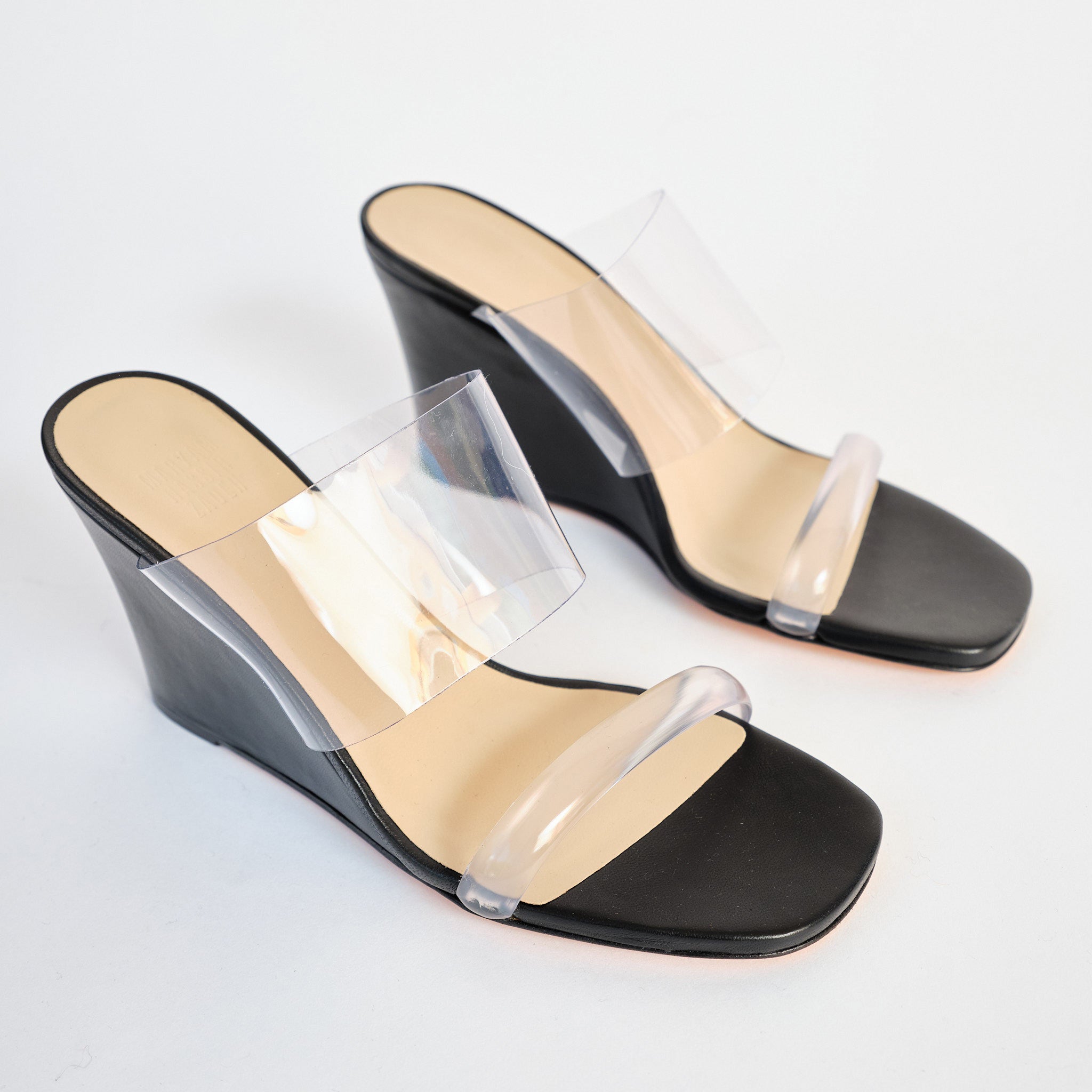 The iconic Olympia Wedge from Maryam Nassir Zadeh in black leather and clear perspex toe strap and vamp - top angled view.