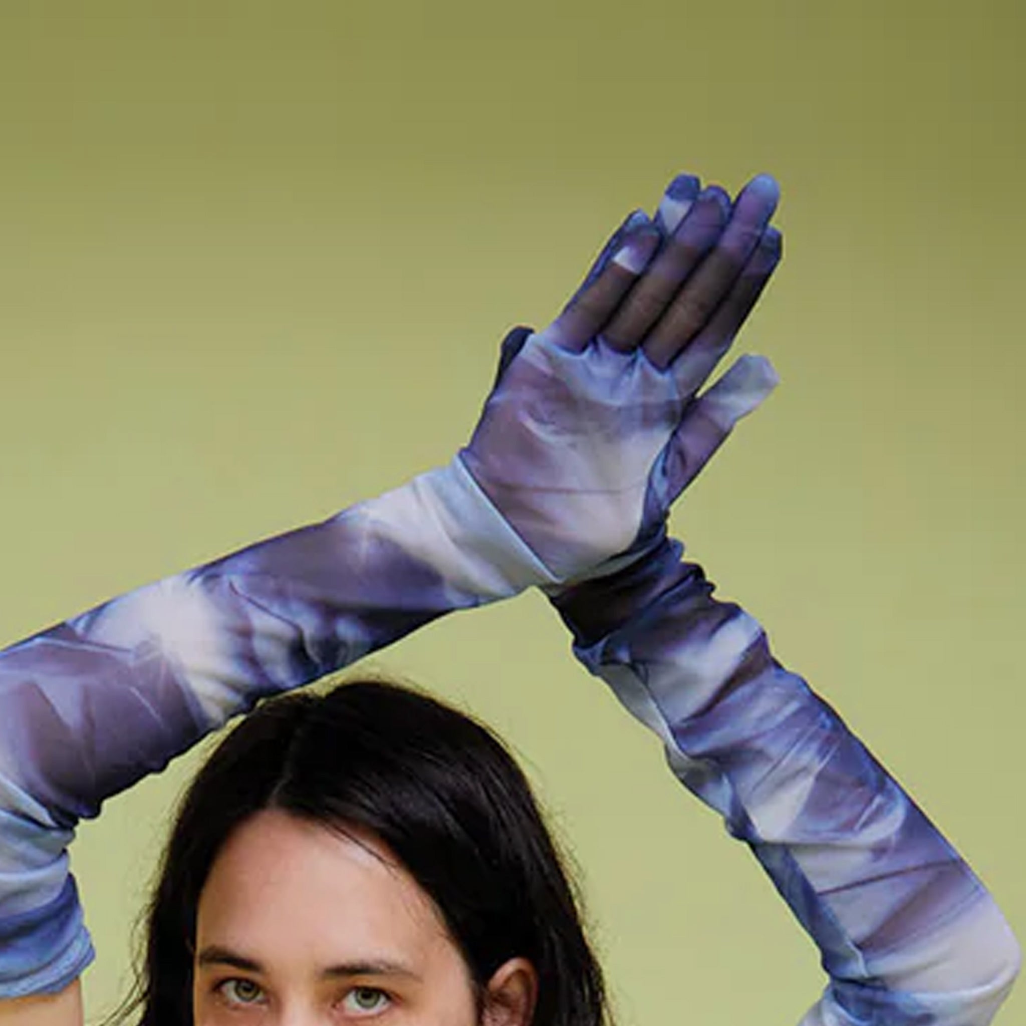A model wears The Opera Gloves in blue and white graphic printed mesh.