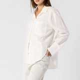 Side half body photo of model wearing the Oversized Button Down Shirt - White.