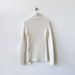 Ribbed white long sleeved mockneck sweater - back view.