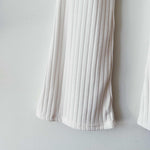 Close detail photo of the Ribbed Knit Flared Pants - Ivory.