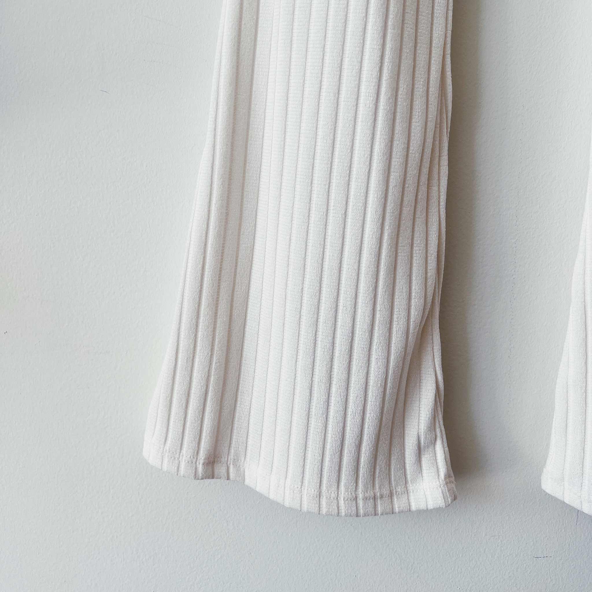 Close detail photo of the Ribbed Knit Flared Pants - Ivory.