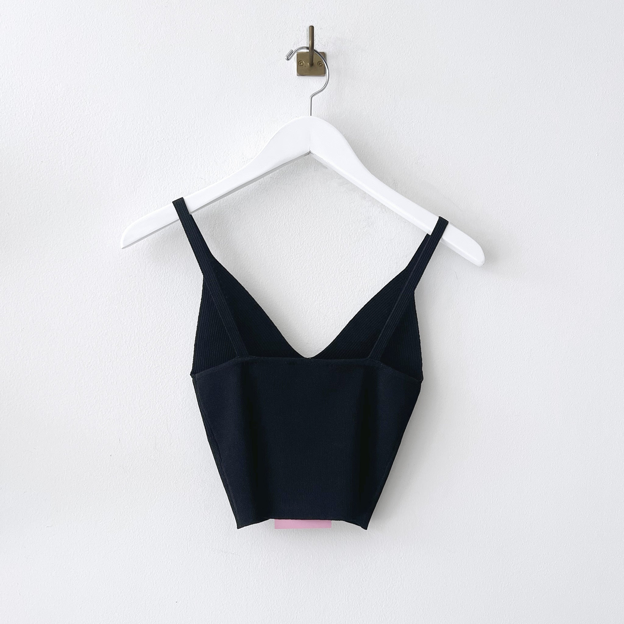 Back hanging photo of the Ribbed Knit Top - Black.