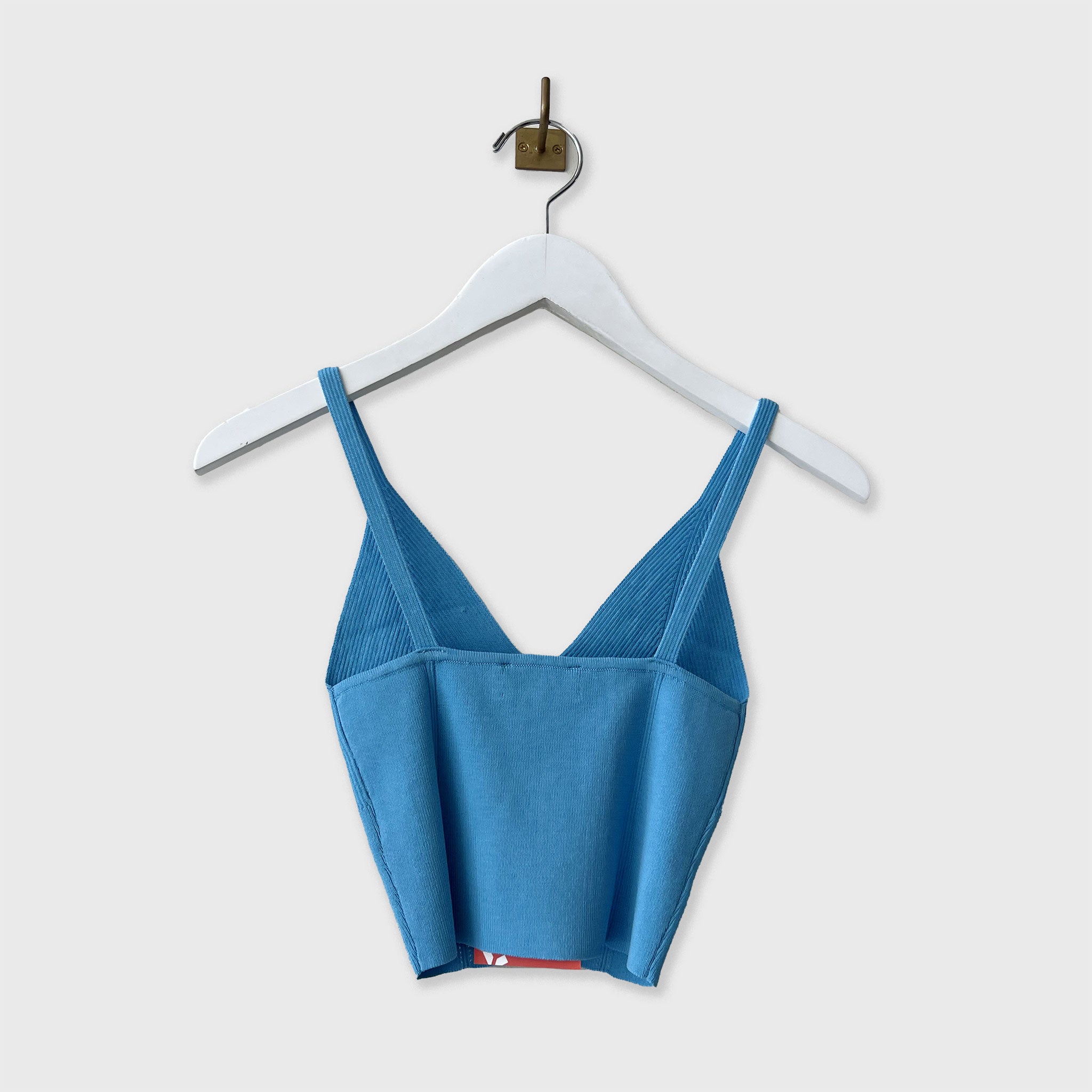 Back hanging photo of the ribbed knit top.