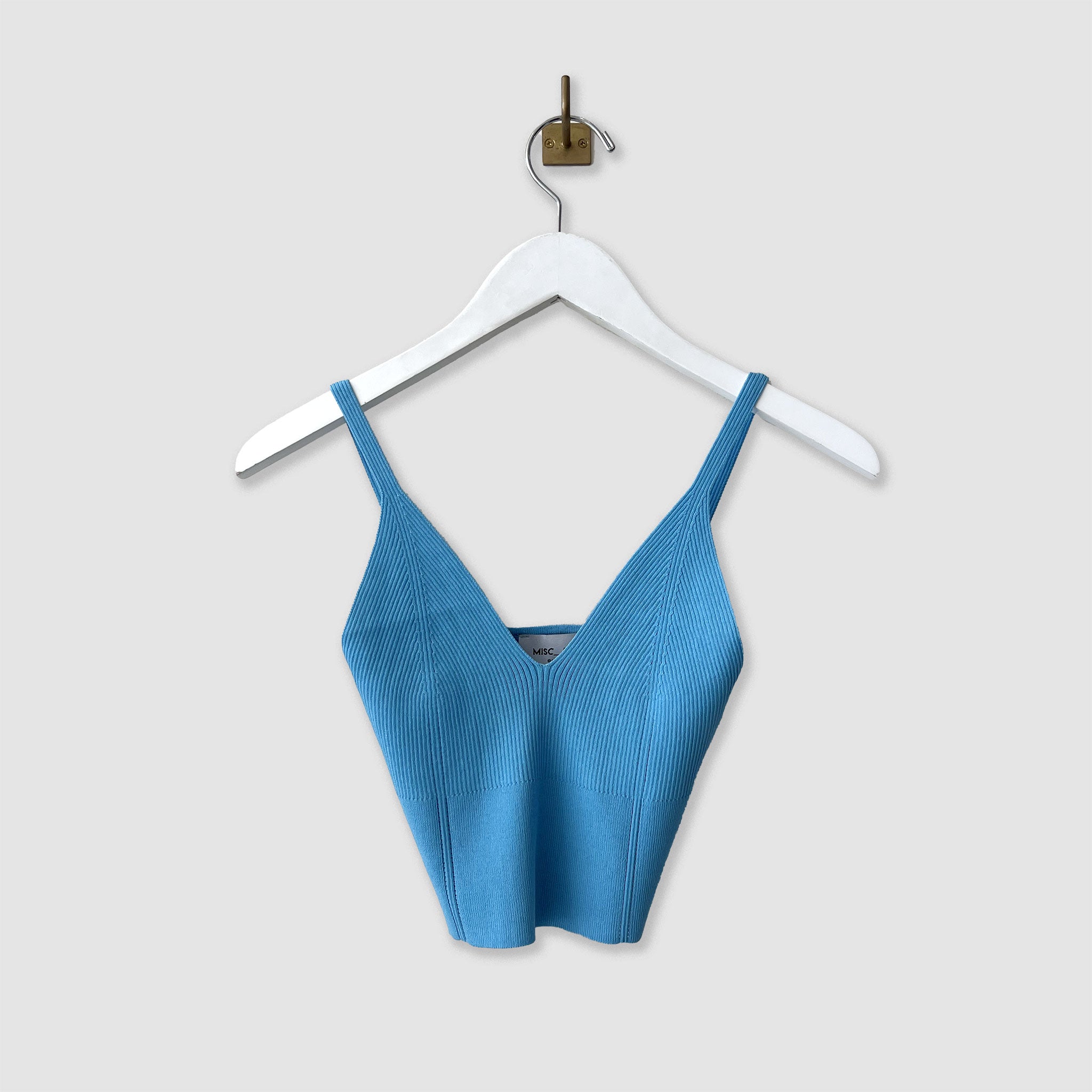 Hanging photo of the ribbed knit top in the color sky blue.