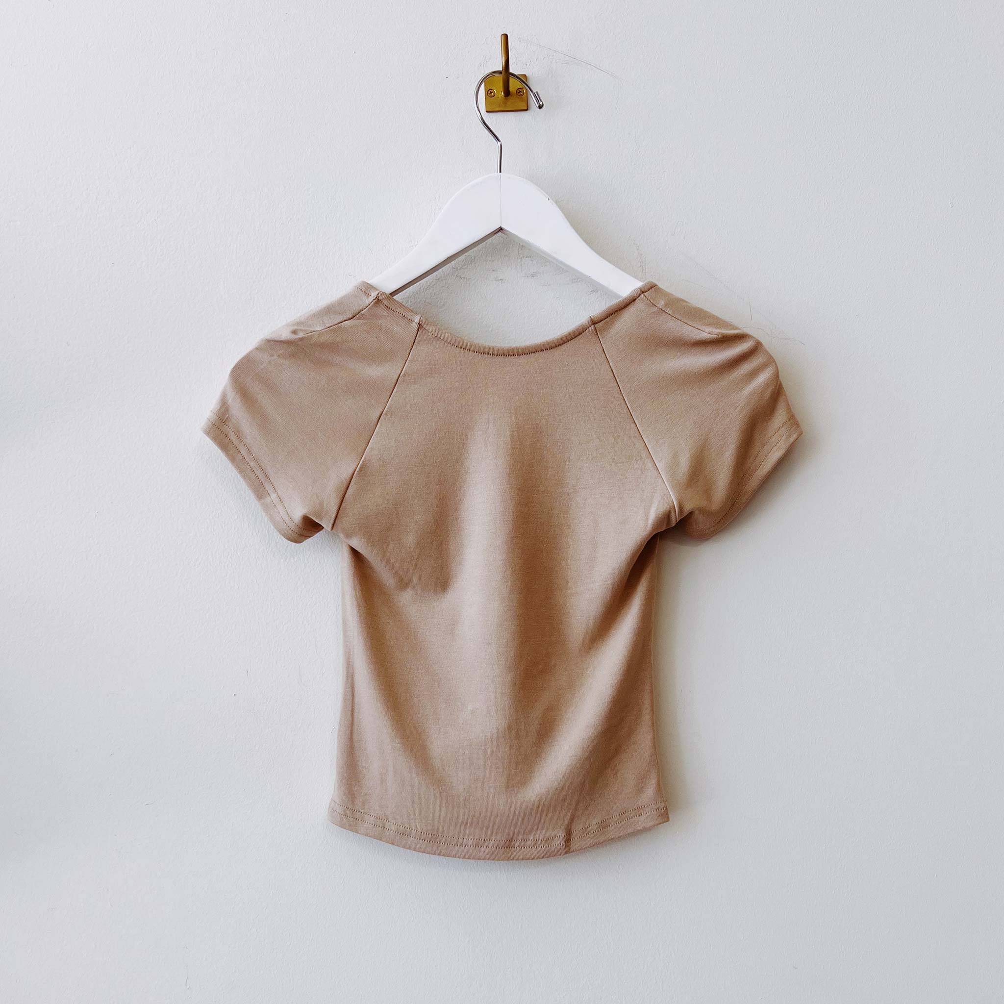 Flat hanging photo of the Ribbed Low Back Tee - Latte.