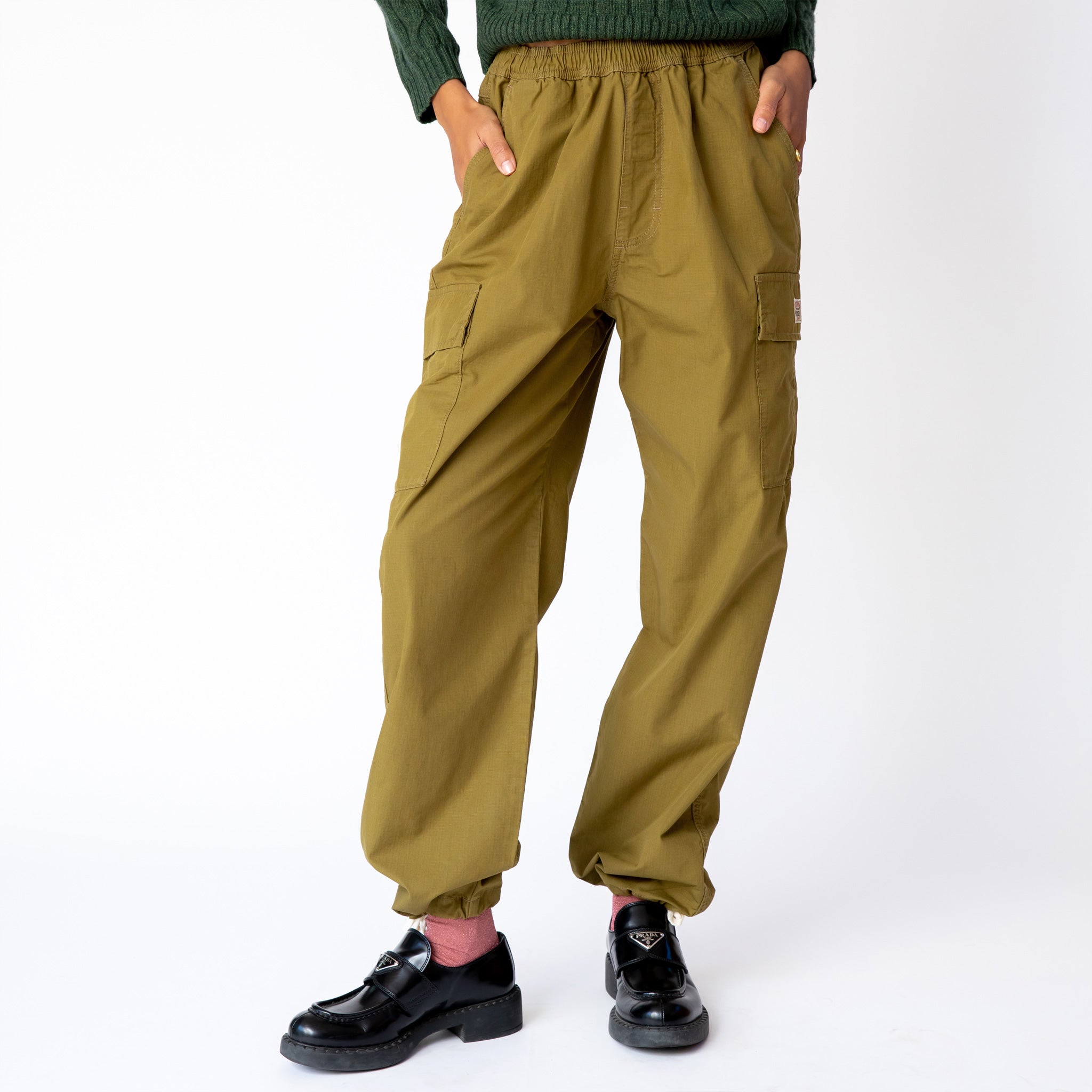 Front view of the Ripstop Cargo Beach Pant by Stussy, paired with black loafers.