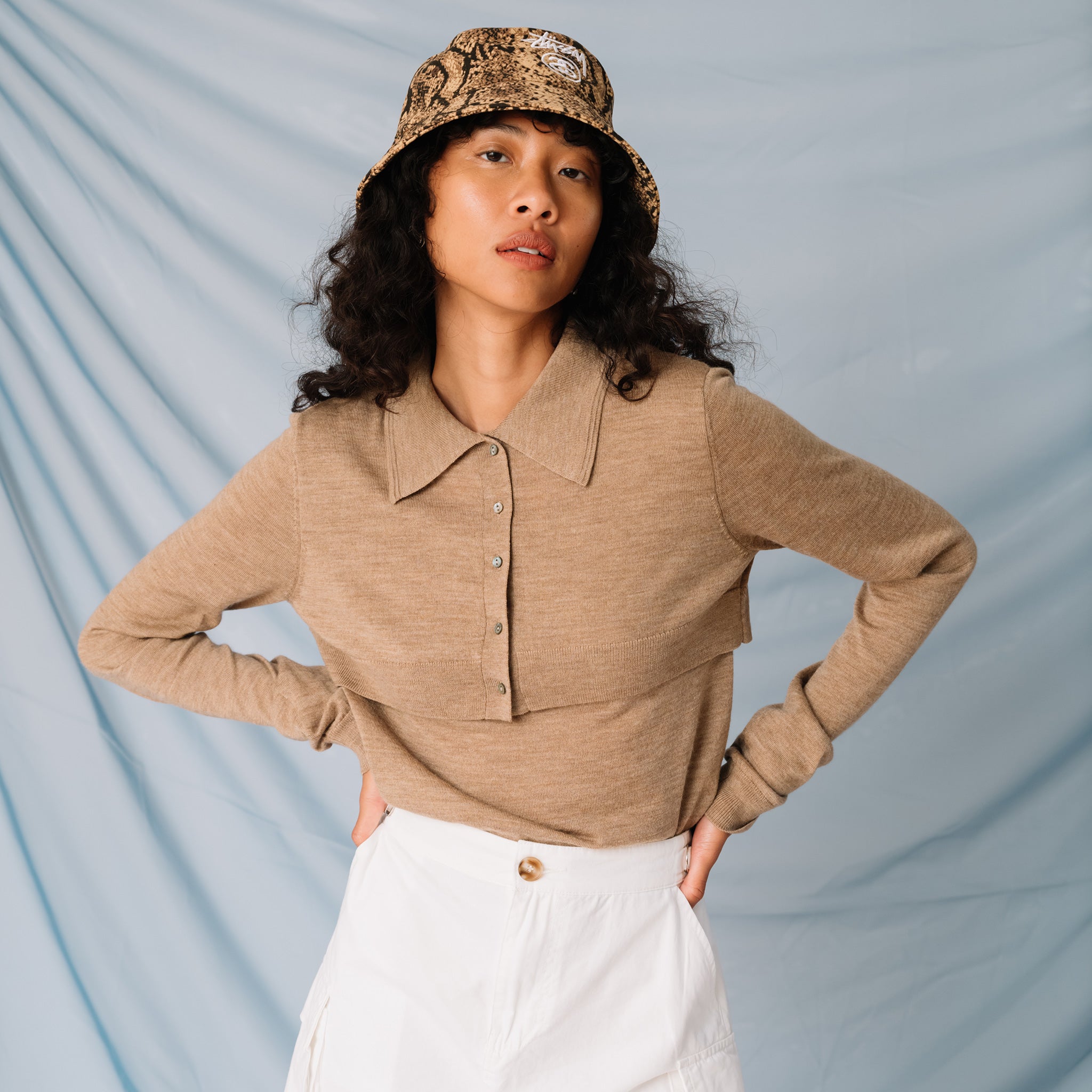 A model wears the lightweight brown cardigan by Sandy Liang, front view.