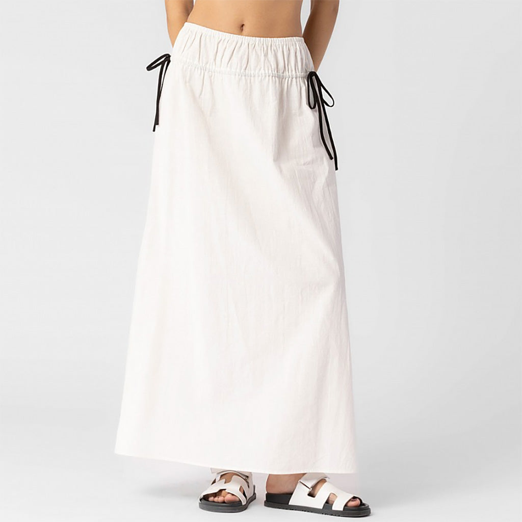 Close half body photo of model wearing the Cotton Side Ribbons Midi Skirt - White.