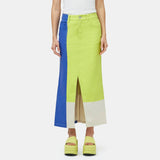 Close half body photo of model wearing the Simi Skirt - a full length denim skirt painted in color blocks of chartreuse, blue, and white - front view.