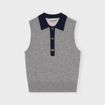 A model wears the frost gray sleeveless polo top with contrasting navy blue collar and gold button hardware - flat image.