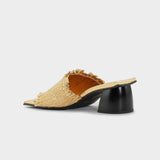 Gold heeled slide with black block heel, square toe, and gold upper, with smocked gold vamp - back view.