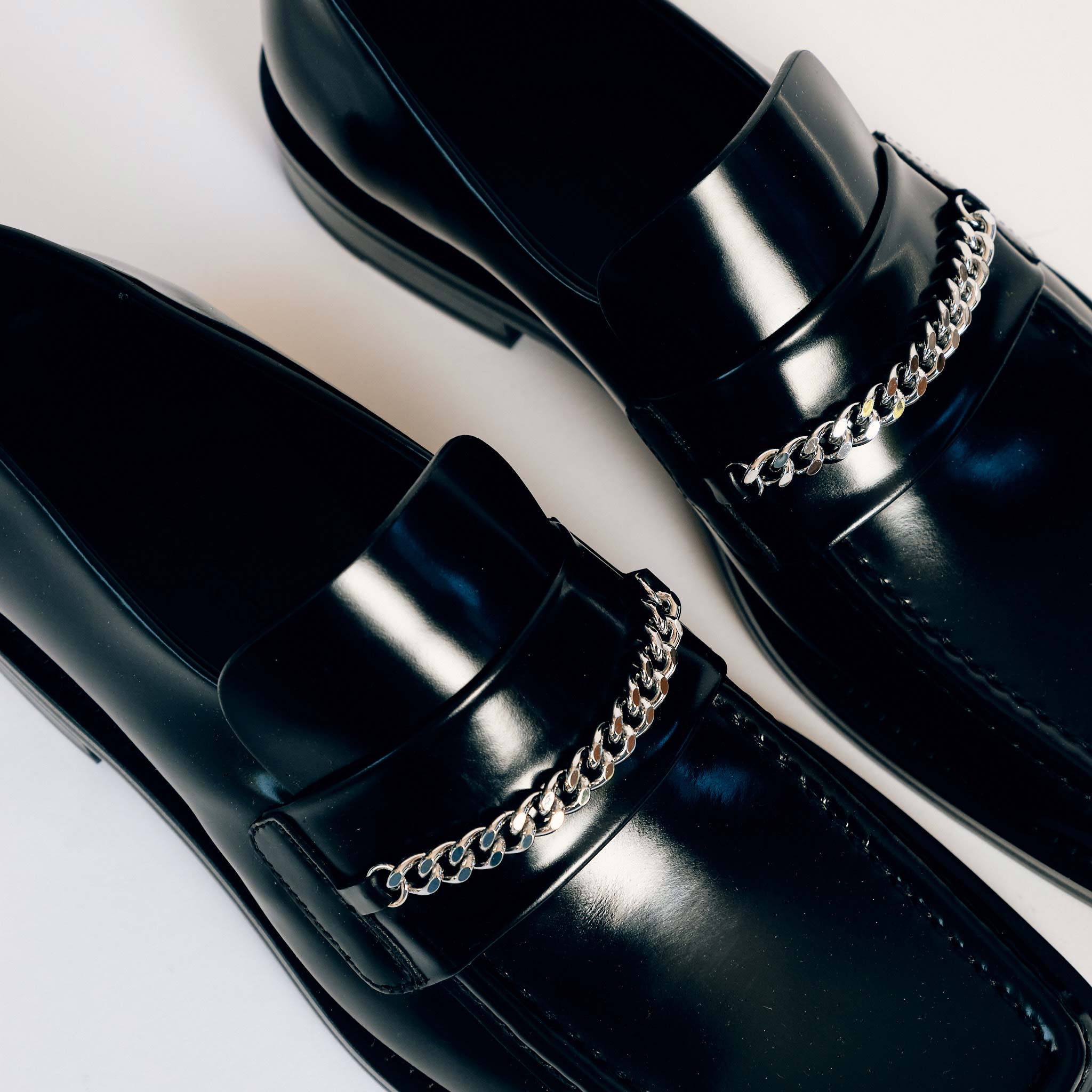 Martine Rose Square Toe Loafer in black shiny leather with a silver chain across the vamp - detailed top down view.