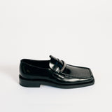 Martine Rose Square Toe Loafer in black shiny leather with a silver chain across the vamp - side view.