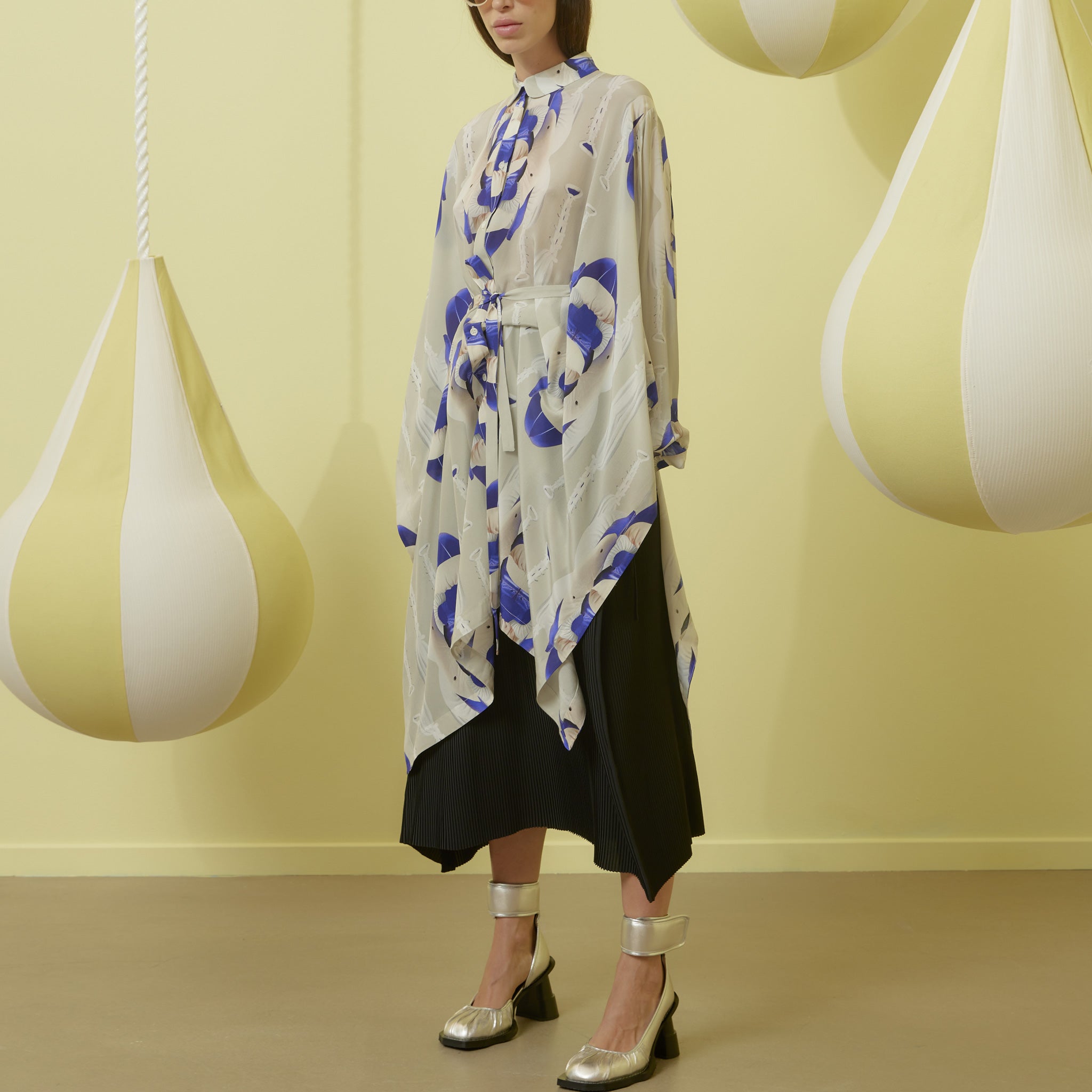 Silk button down shirt dress in white featuring blue graphics and a waist tie.