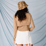 Back view of a model wearing the Stock Lock Deep Bucket Hat by Stussy featuring an allover python brown print and white Stussy logo embroidery.