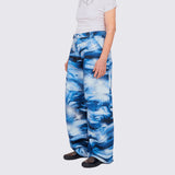 A model wears the cotton wide-legged Stomp Pant, featuring a blue and white aquatic inspired all over print, large front and side pockets.