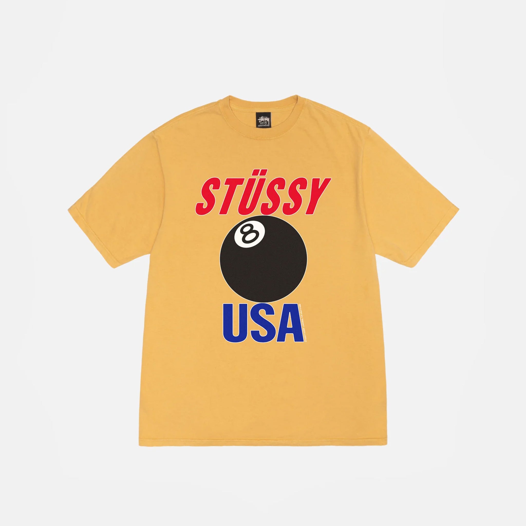 A short sleeved t-shirt with a large screen print graphic of the words STUSSY USA in red and blue and a large black 8-Ball between the words.