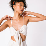 A model wears the Tie Cami Top and large silver hoop earrings.