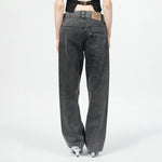 Back half body photo of model wearing the Womens Twisted Seam Jeans - Dark Brown.