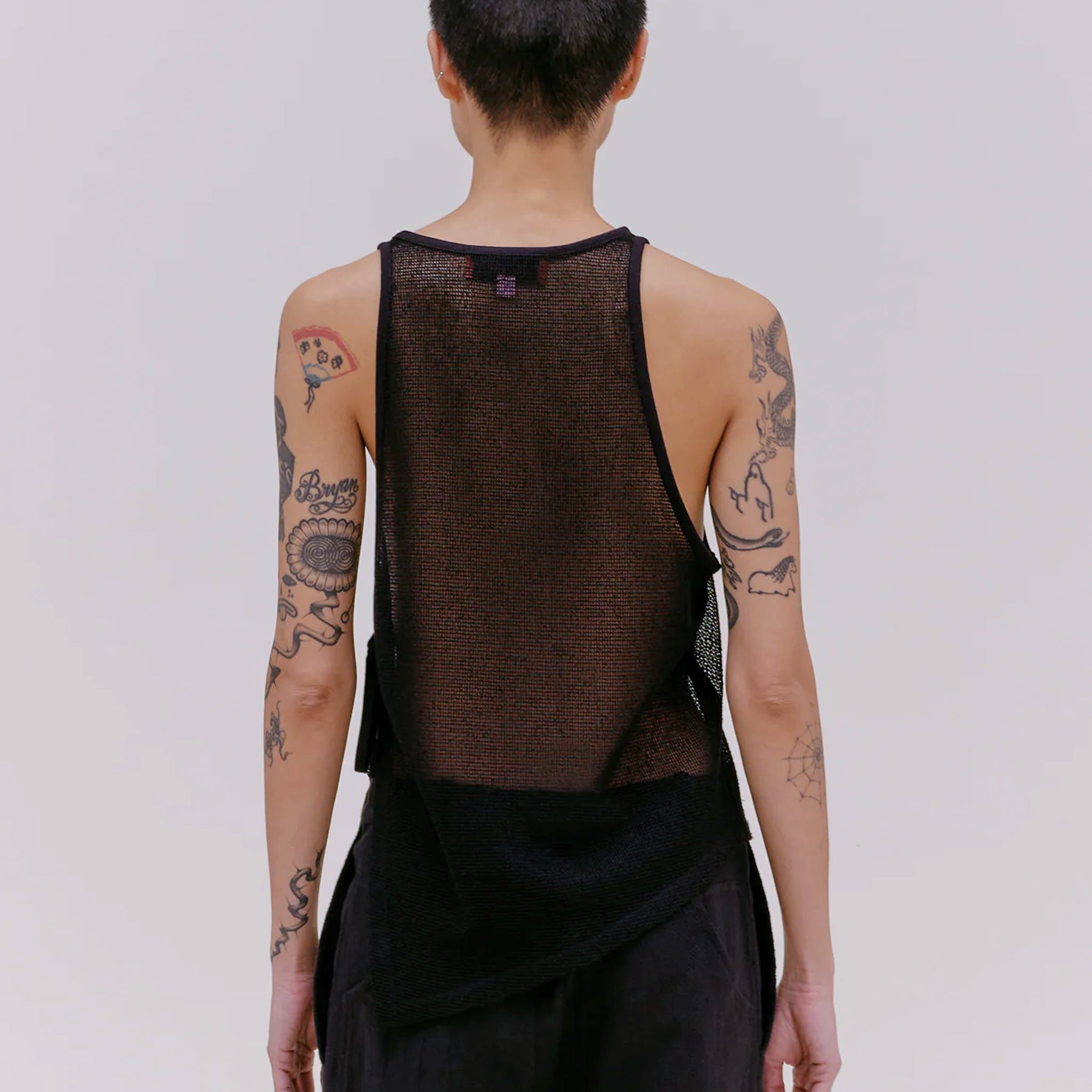 Back half body photo of model wearing the mesh UV tank in the color midnight. 