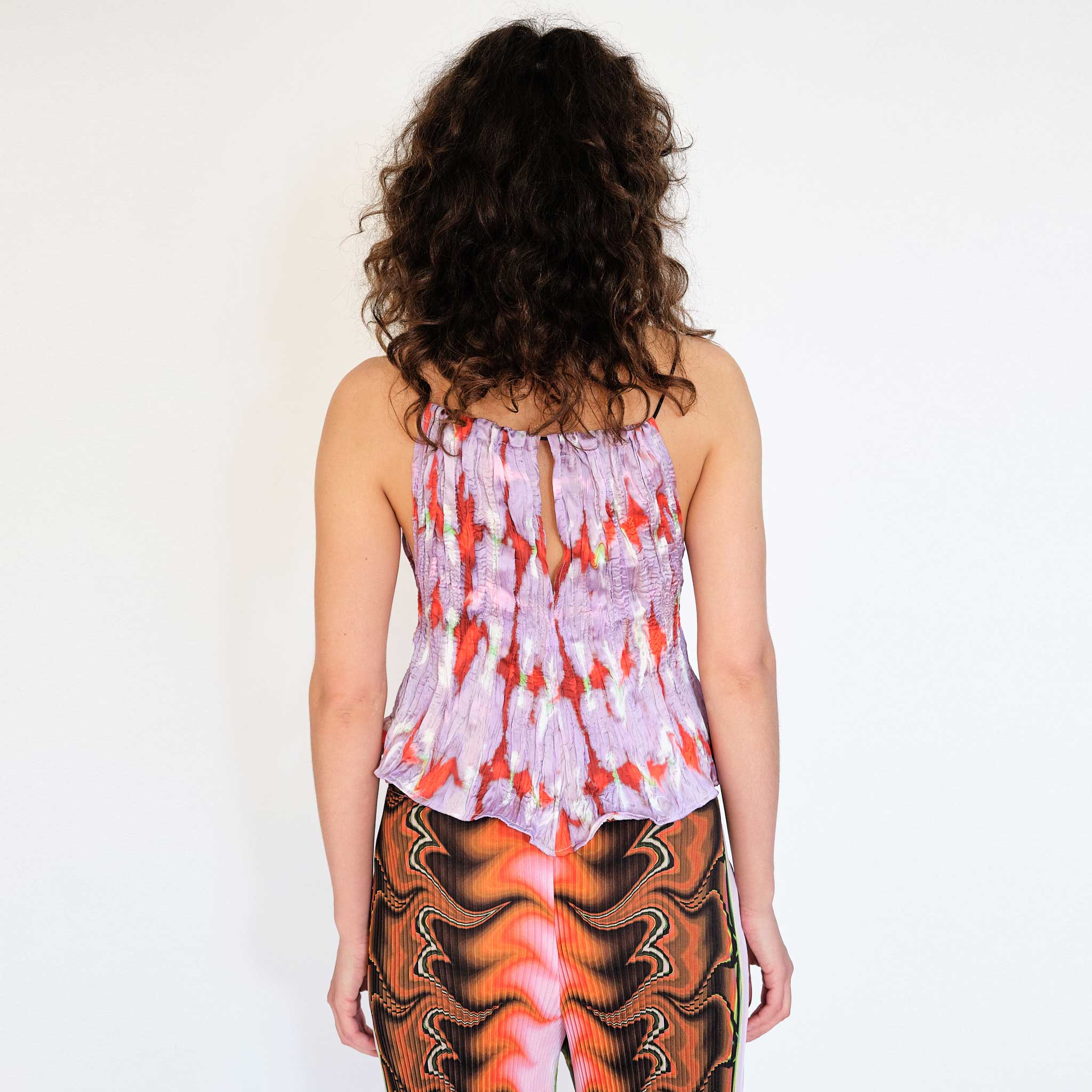 A model wears the lightweight Wendy tank top in the purple Wallace graphic print - back view.