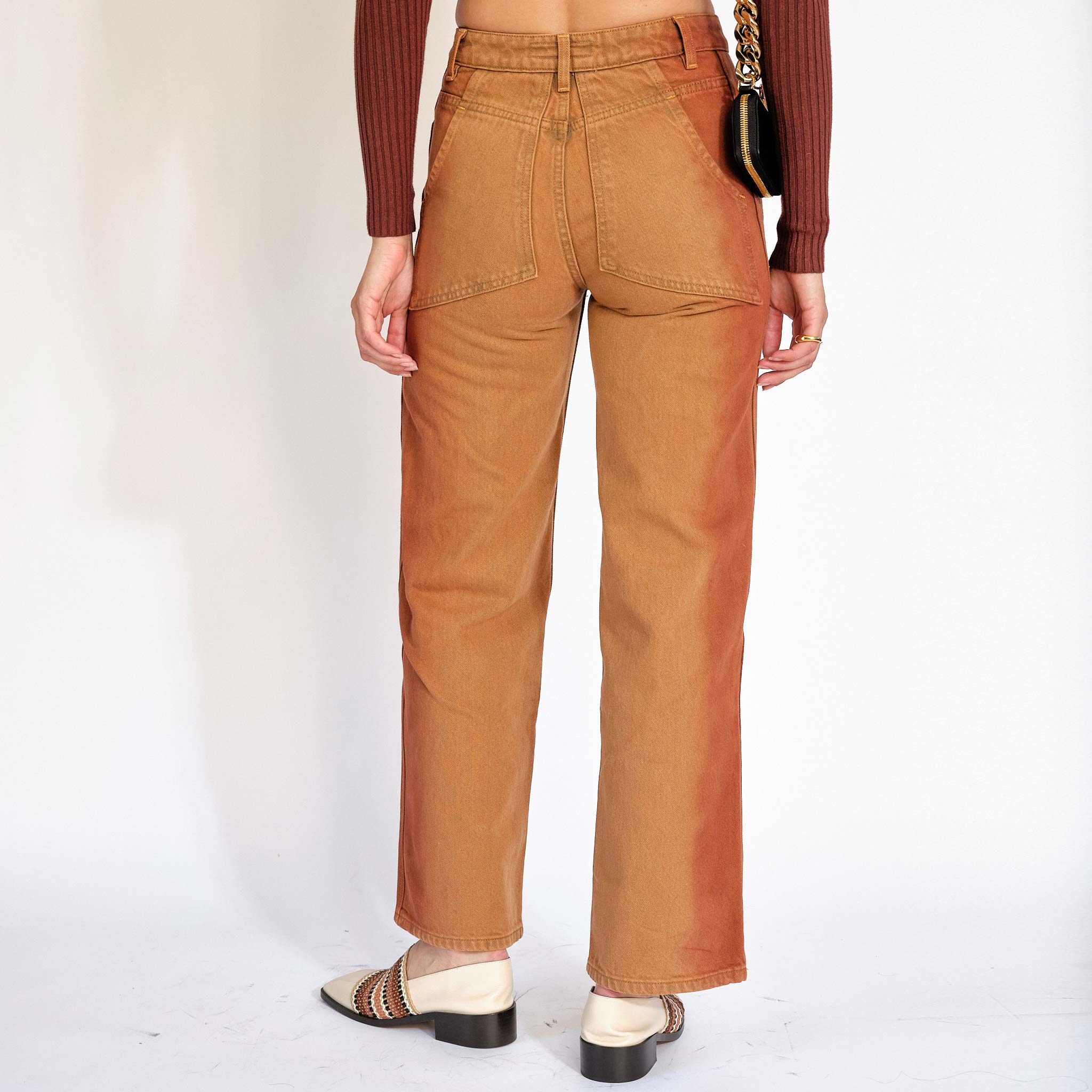 Half body photo of the Eckhaus Latta Wide Leg Jeans in terracotta - back view.