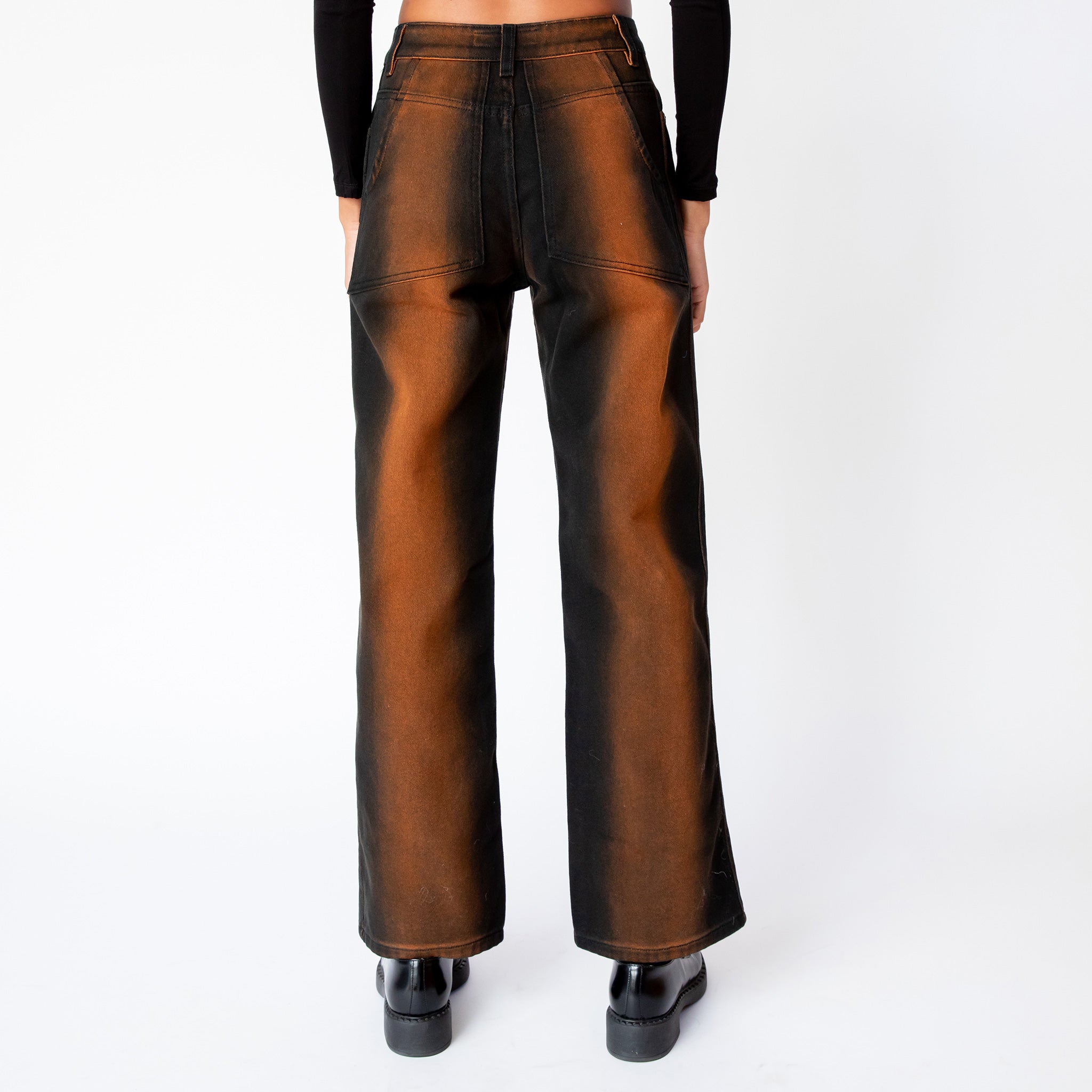 Back view of the Eckhaus Latta's wide leg jeans in ozone, featuring a vertical stripe of rust brown that gradients to black along the sides of the leg.